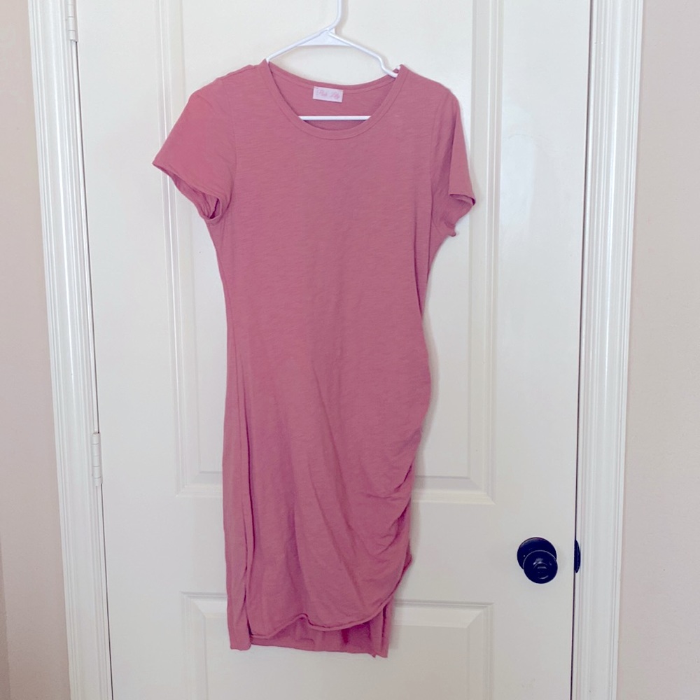 Mid length tight fitted pink dress with short sleeves.